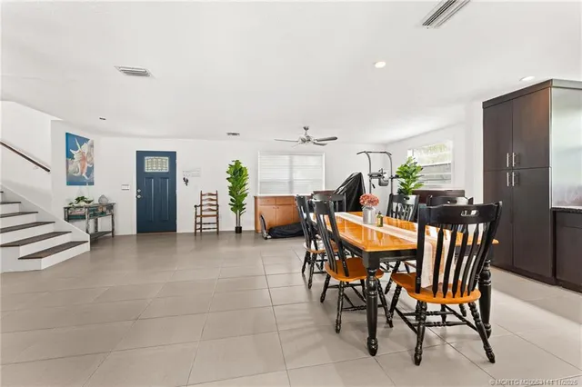 a front view of a house with swimming pool having outdoor seating