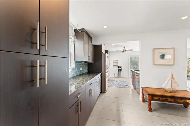 a view of a patio with table and chairs and potted plants