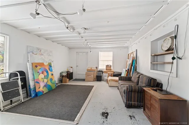 an aerial view of residential houses with outdoor space and trees