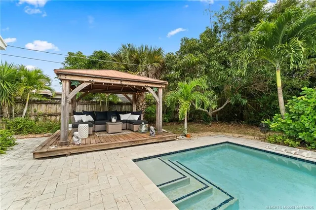an aerial view of residential houses with outdoor space and trees