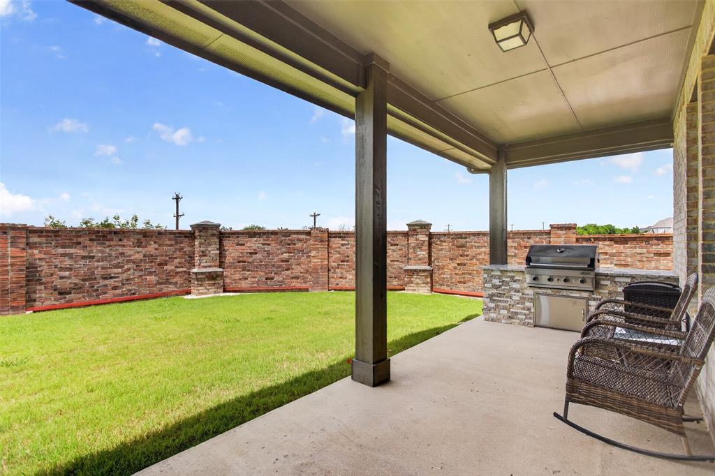 1002 Coppersmith Way Forney, TX 75126 - Photo 5 of 39 a view of a terrace with a floor to ceiling window and yard