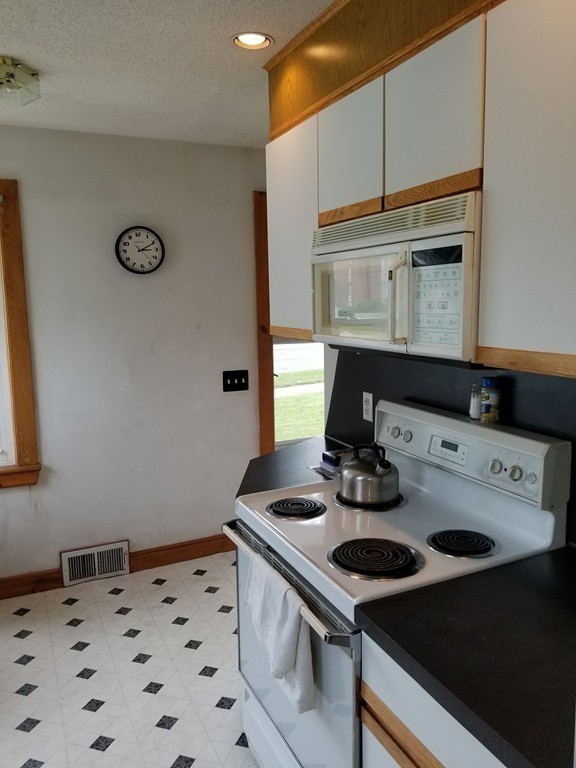 7 Lancaster Street Springfield, MA 01118 - Photo 12 of 25 a kitchen with a sink stove and microwave
