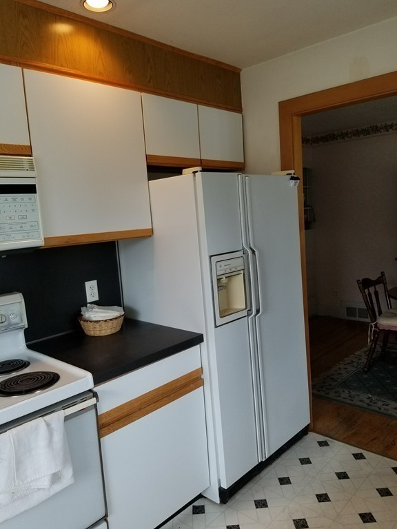 7 Lancaster Street Springfield, MA 01118 - Photo 13 of 25 a kitchen with stainless steel appliances a stove and a refrigerator