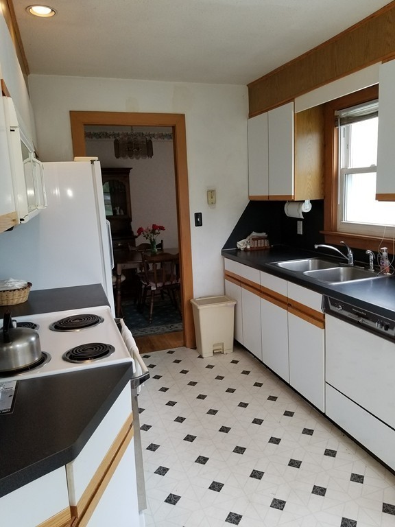 7 Lancaster Street Springfield, MA 01118 - Photo 14 of 25 a kitchen with a sink a stove and cabinets
