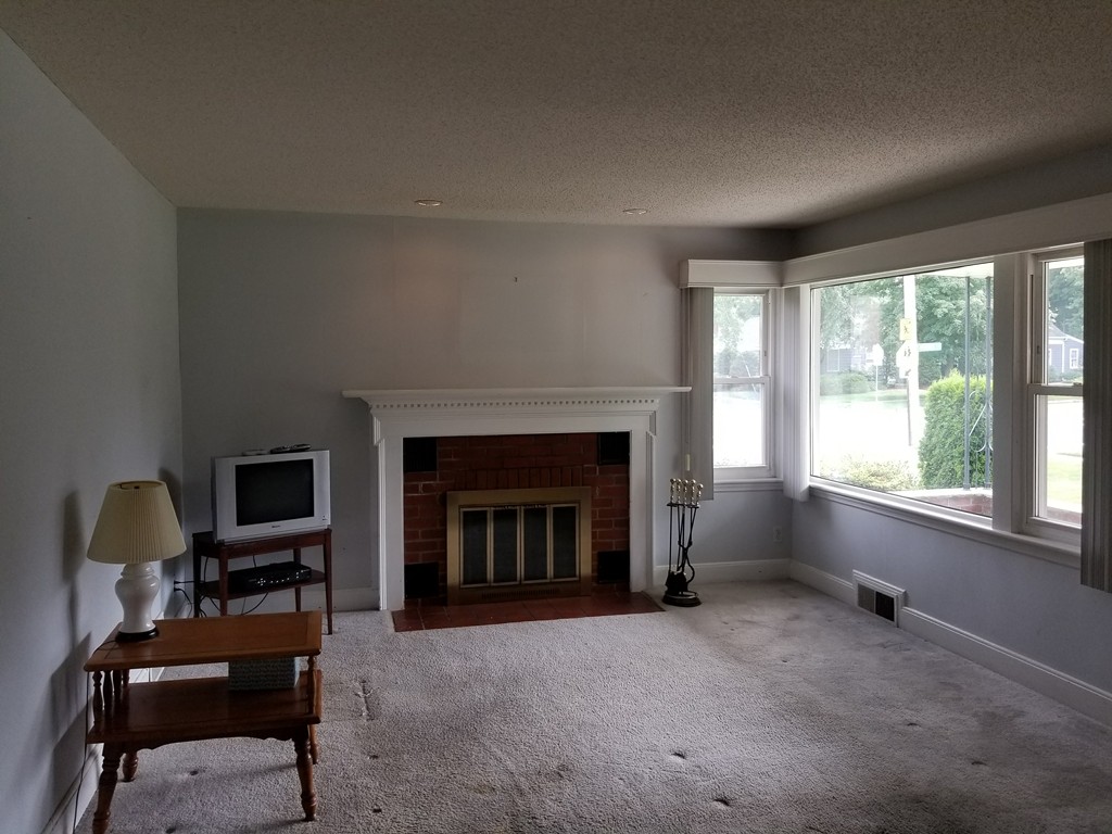 7 Lancaster Street Springfield, MA 01118 - Photo 15 of 25 a living room with furniture and a fireplace
