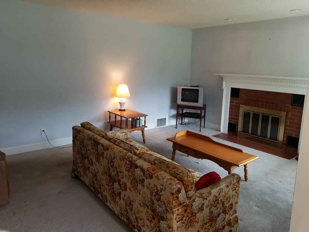 7 Lancaster Street Springfield, MA 01118 - Photo 16 of 25 a living room with furniture and a fireplace