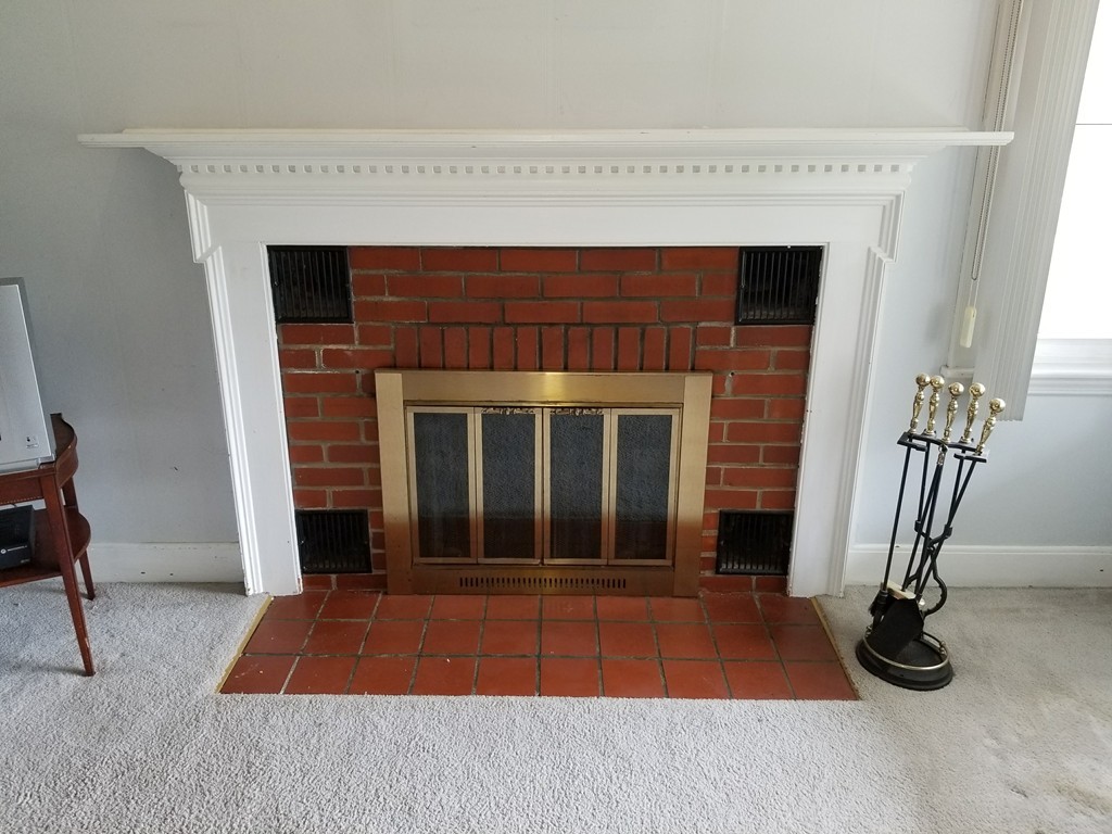 7 Lancaster Street Springfield, MA 01118 - Photo 17 of 25 a view of backyard with a fireplace and a window