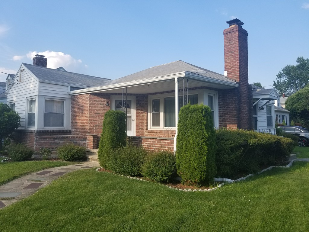 7 Lancaster Street Springfield, MA 01118 - Photo 2 of 25 a front view of a house with garden
