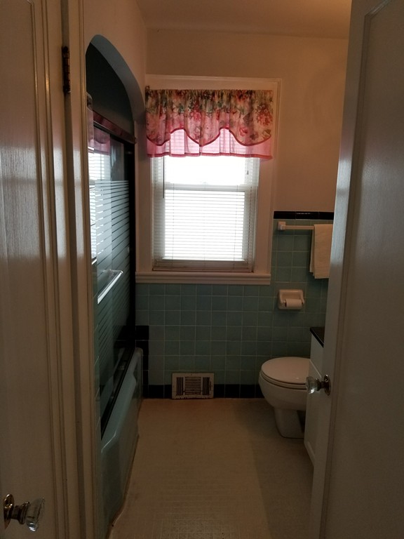 7 Lancaster Street Springfield, MA 01118 - Photo 22 of 25 a bathroom with a toilet sink and mirror