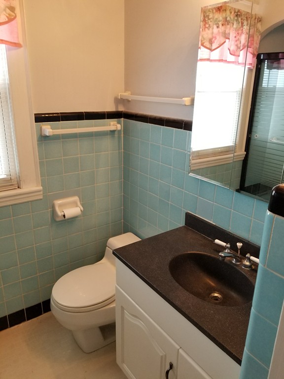 7 Lancaster Street Springfield, MA 01118 - Photo 23 of 25 a bathroom with a sink a toilet and a mirror
