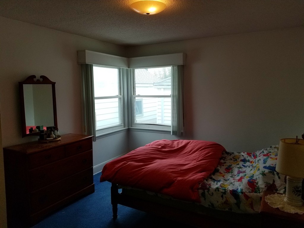 7 Lancaster Street Springfield, MA 01118 - Photo 24 of 25 a bedroom with a bed and a mirror