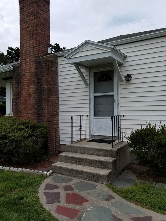 7 Lancaster Street Springfield, MA 01118 - Photo 4 of 25 a front view of a house with a garden
