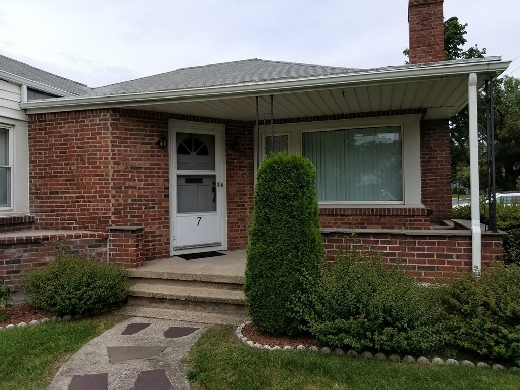 7 Lancaster Street Springfield, MA 01118 - Photo 5 of 25 a front view of a house with a garden