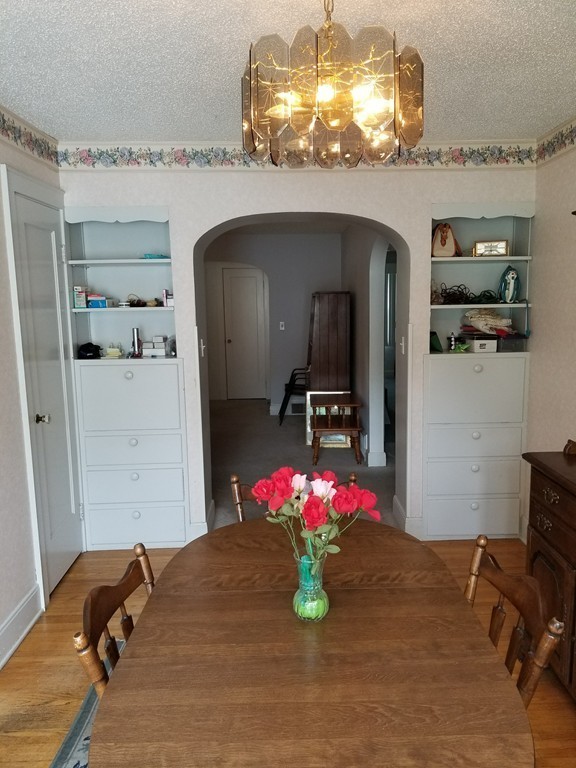 7 Lancaster Street Springfield, MA 01118 - Photo 8 of 25 a bed room with a bed mirror and a chandelier