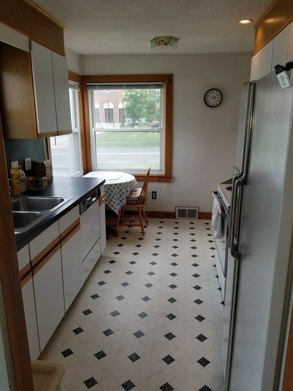 7 Lancaster Street Springfield, MA 01118 - Photo 10 of 25 a kitchen with a sink a stove a refrigerator and a large window