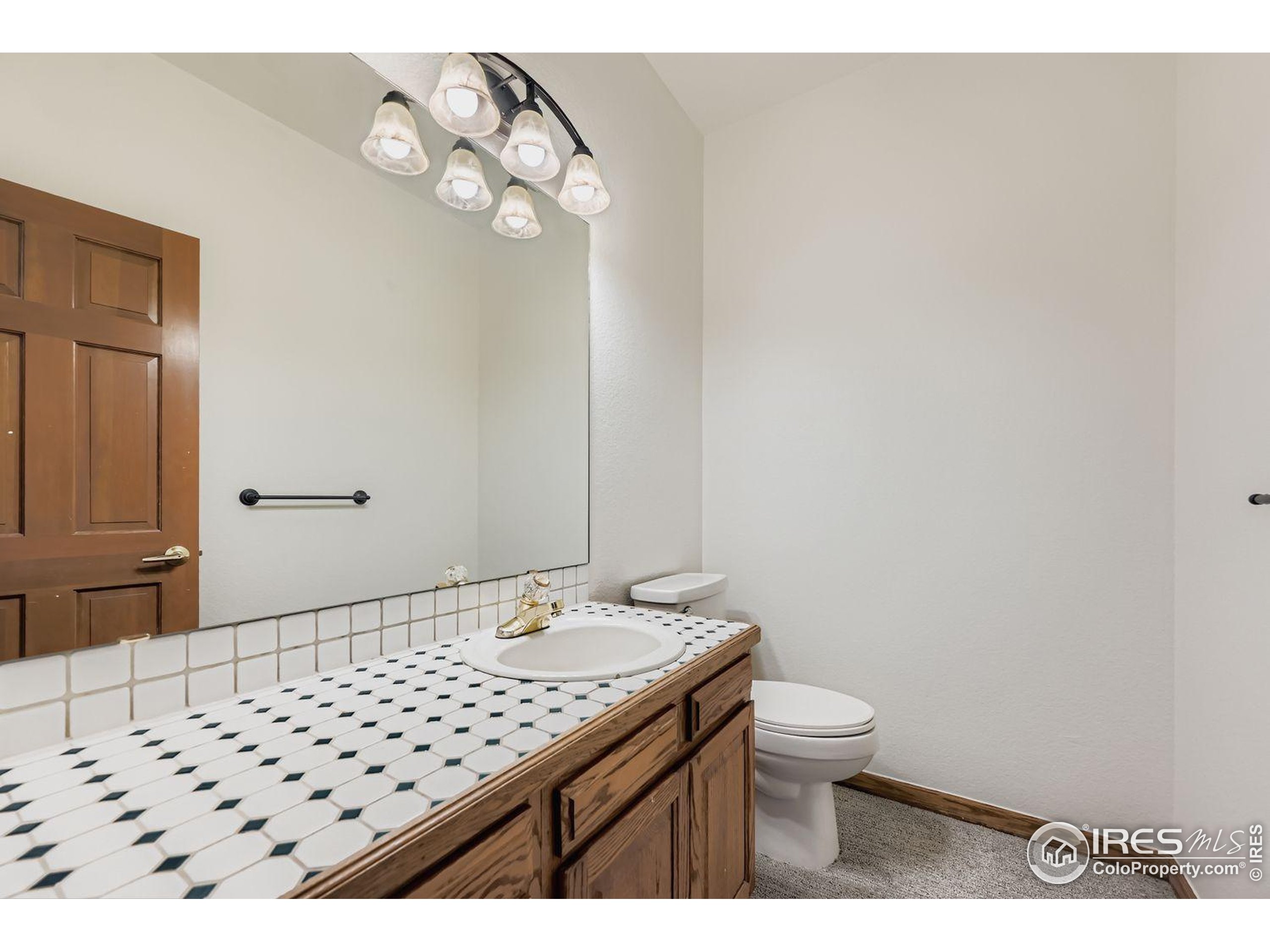 2062 Ridgeview Drive Longmont, CO 80504 - Photo 12 of 29 a bathroom with a sink a toilet and mirror