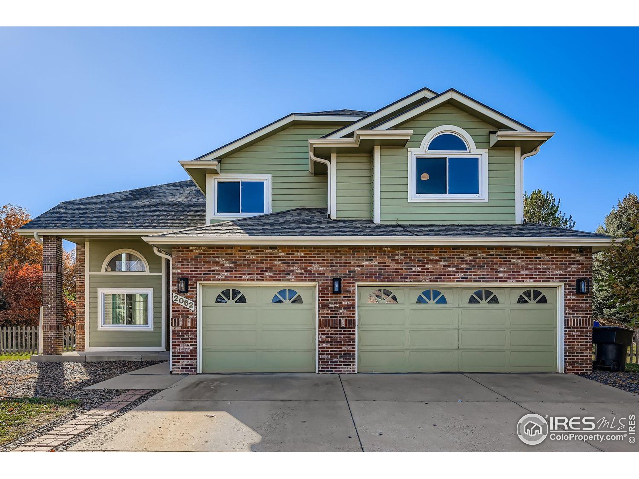 2062 Ridgeview Drive Longmont, CO 80504 - Photo 29 of 29 a front view of a house with a garden and garage