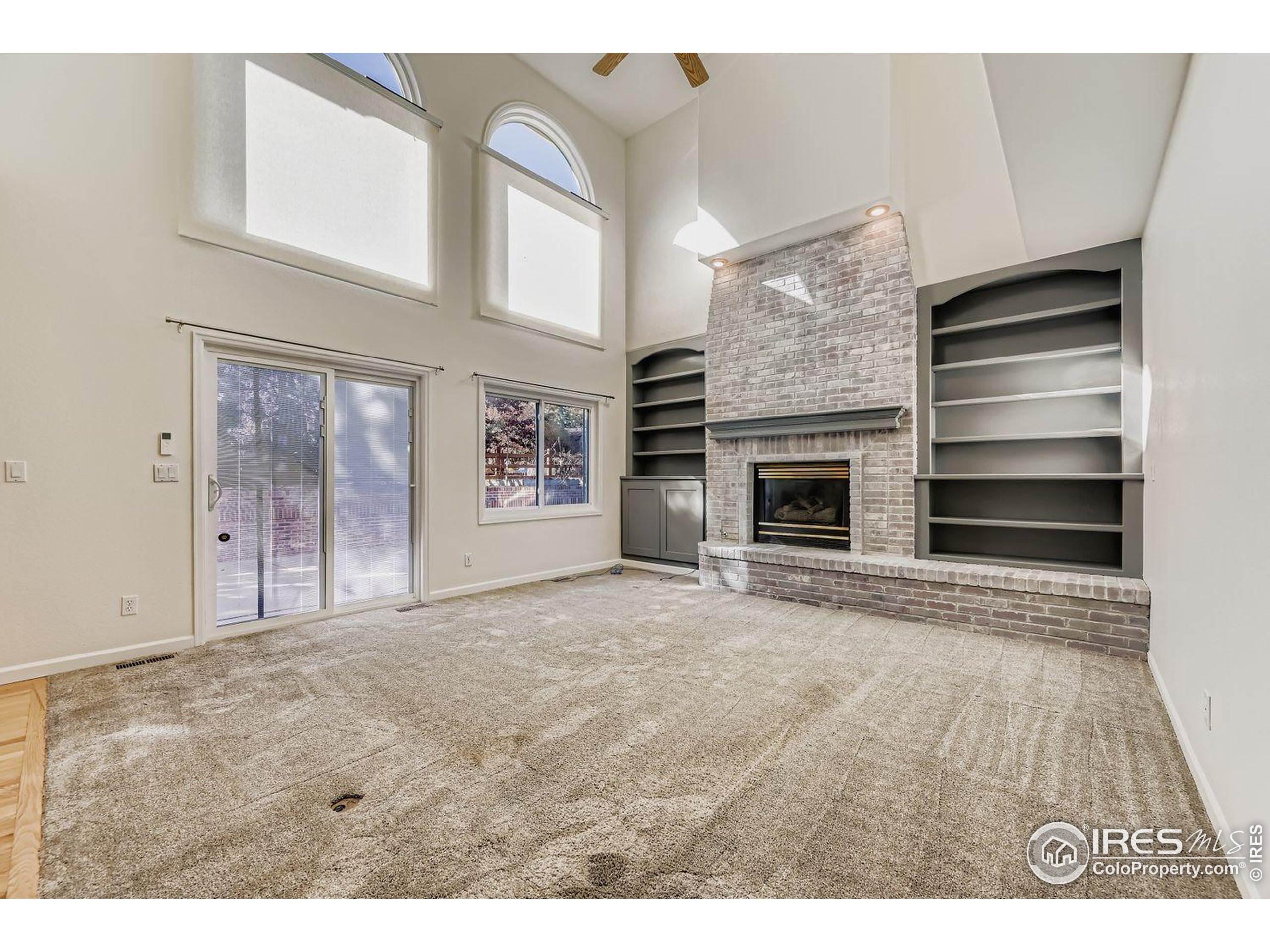 2062 Ridgeview Drive Longmont, CO 80504 - Photo 4 of 29 a view of an empty room with a fireplace and a window