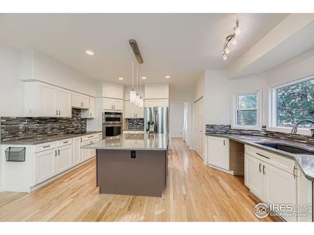 a kitchen with stainless steel appliances granite countertop a stove and a sink