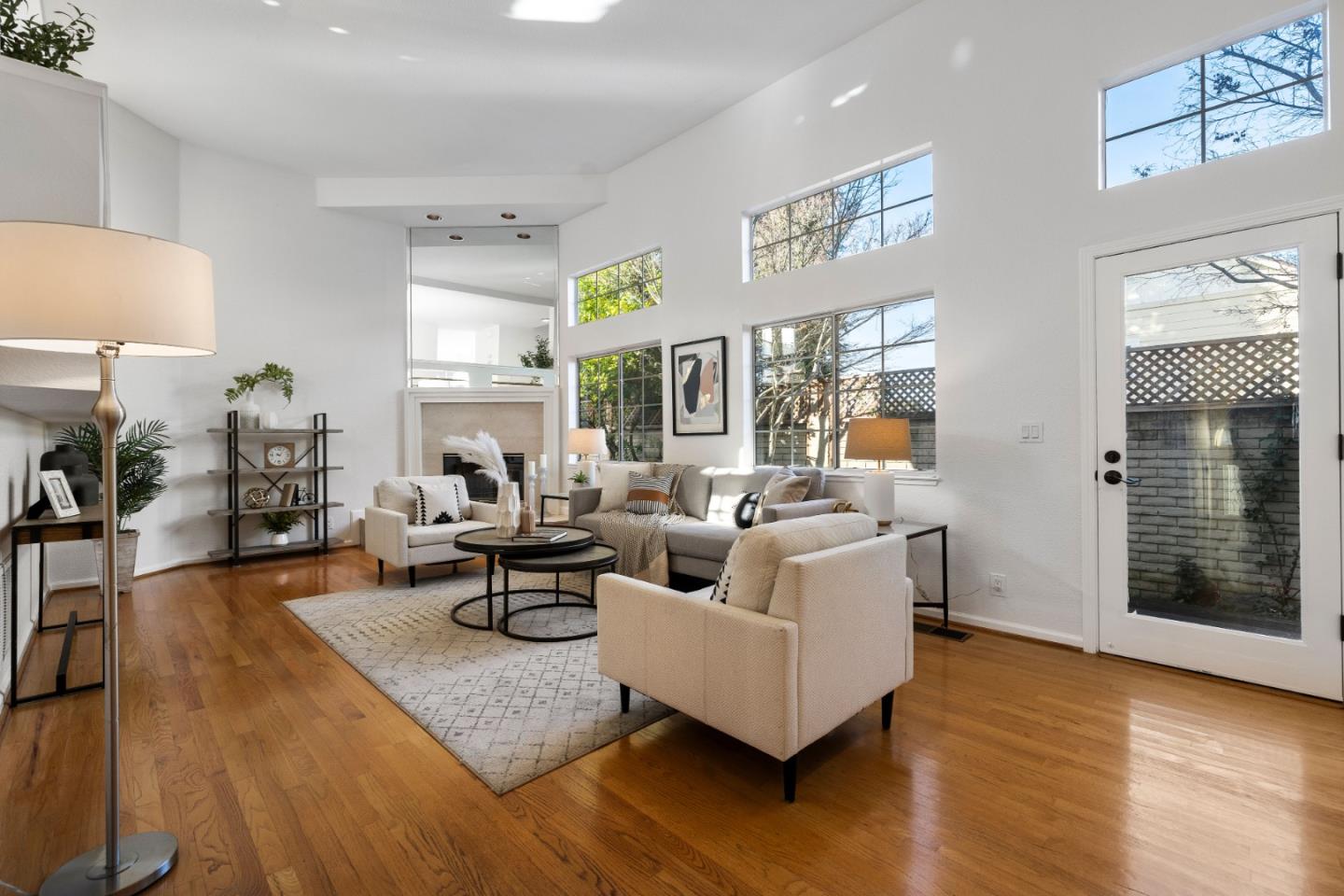 a living room with fireplace furniture and a wooden floor