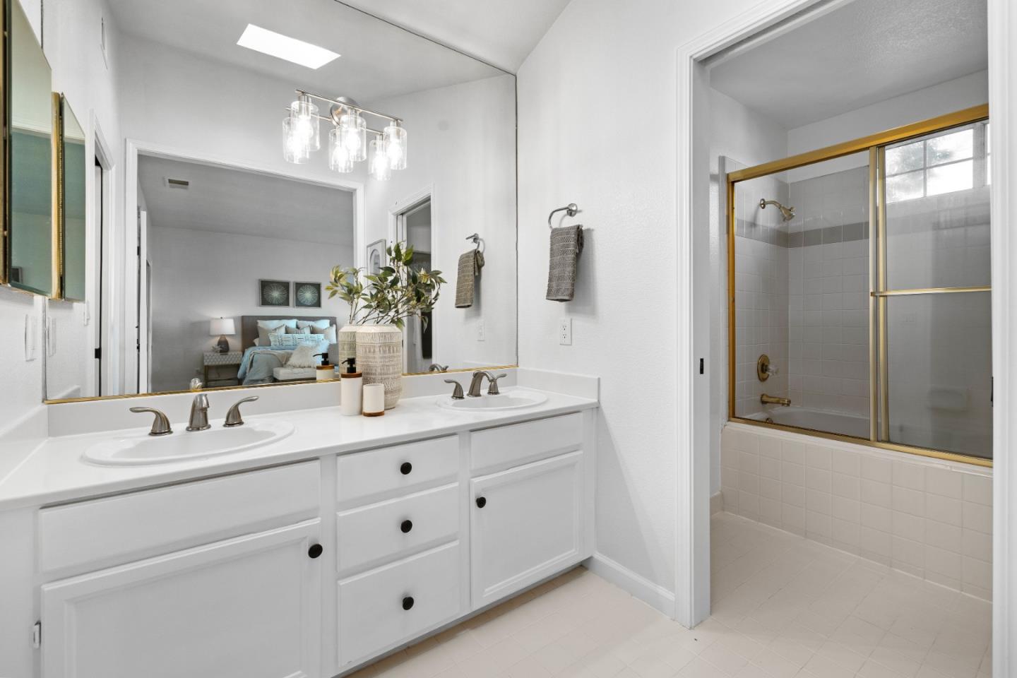 20659 Gardenside Circle Cupertino, CA 95014 - Photo 19 of 55 a bathroom with double sink and a mirror