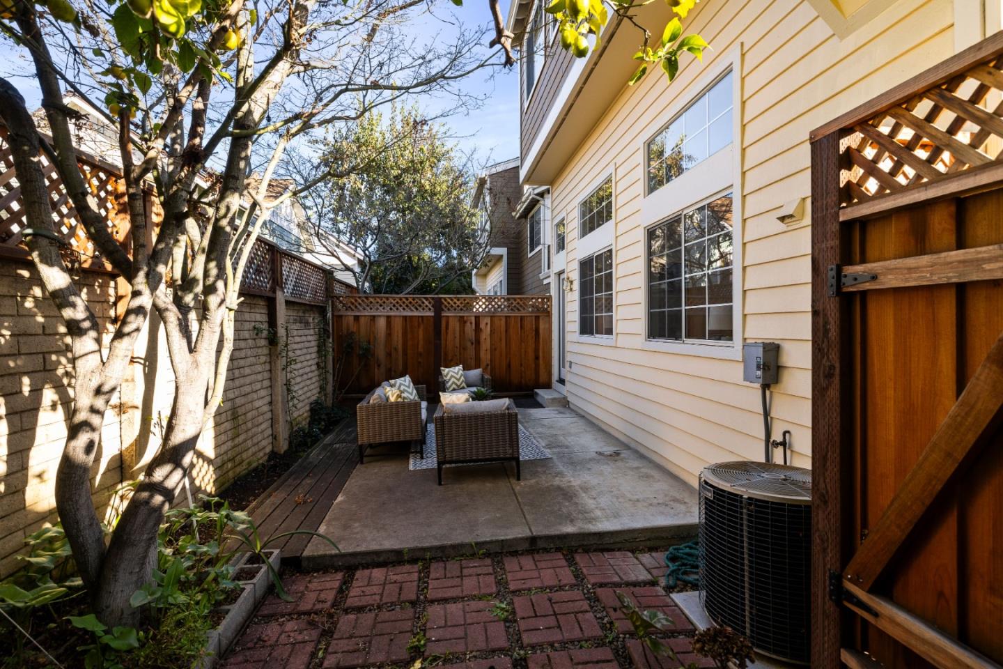 20659 Gardenside Circle Cupertino, CA 95014 - Photo 25 of 55 a view of a patio with a table and chairs and wooden fence