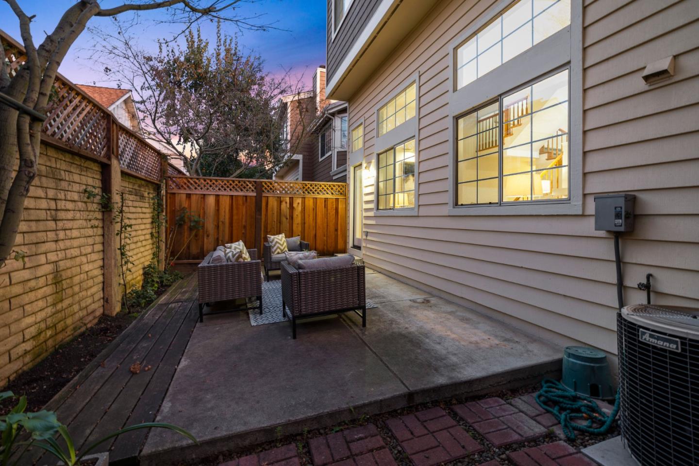 20659 Gardenside Circle Cupertino, CA 95014 - Photo 34 of 55 a view of a patio with table and chairs and couches with wooden floor and fence