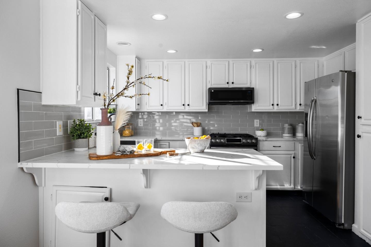 20659 Gardenside Circle Cupertino, CA 95014 - Photo 6 of 55 a kitchen with stainless steel appliances granite countertop a sink refrigerator a microwave a stove and white cabinets