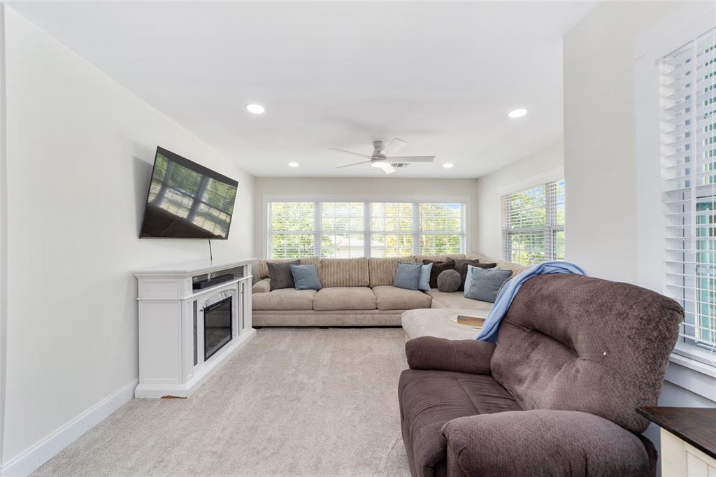 9040 Southwest 209th Circle Dunnellon, FL 34431 - Photo 11 of 55 a living room with furniture and a flat screen tv