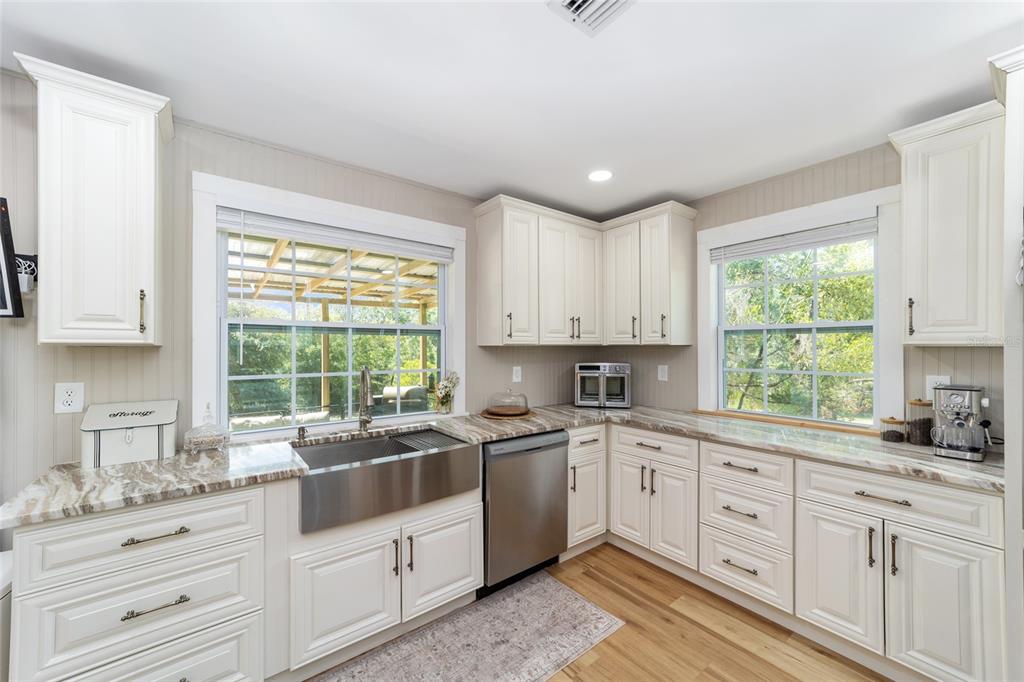 9040 Southwest 209th Circle Dunnellon, FL 34431 - Photo 21 of 55 a kitchen that has a sink and a stove in it