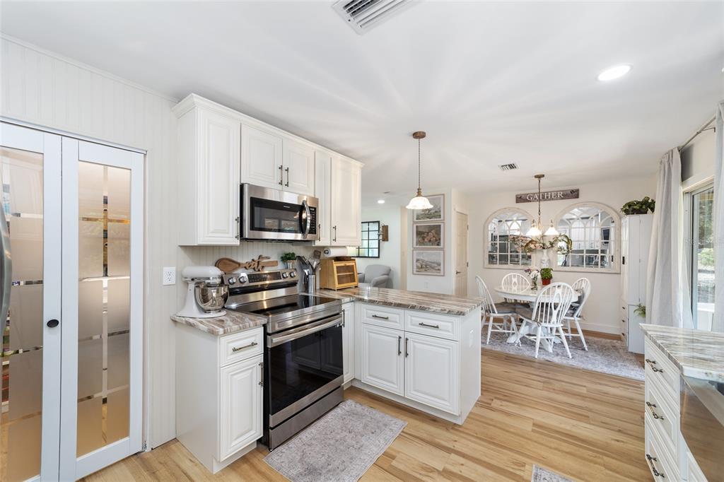 9040 Southwest 209th Circle Dunnellon, FL 34431 - Photo 23 of 55 a kitchen with a sink stove and refrigerator
