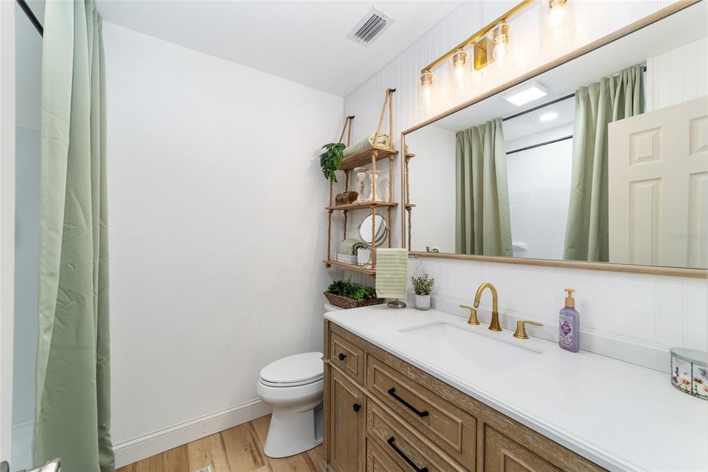 9040 Southwest 209th Circle Dunnellon, FL 34431 - Photo 27 of 55 a bathroom with a granite countertop sink toilet and mirror