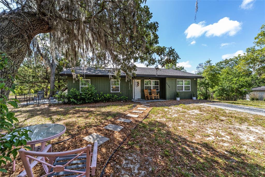 9040 Southwest 209th Circle Dunnellon, FL 34431 - Photo 3 of 55 a front view of a house with a yard and garage