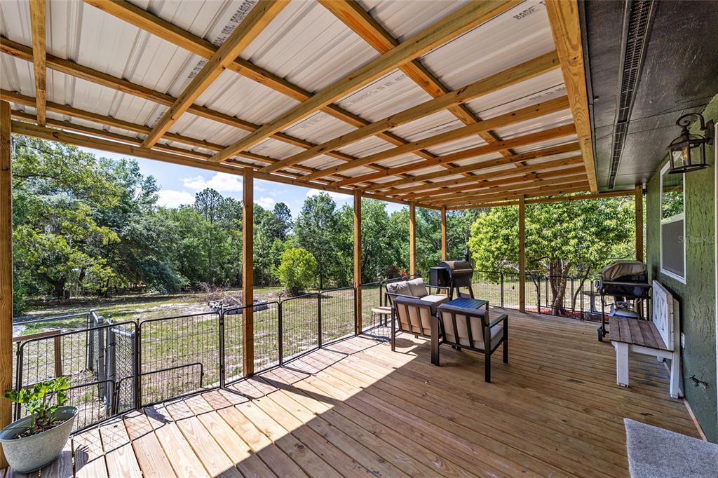 9040 Southwest 209th Circle Dunnellon, FL 34431 - Photo 33 of 55 a view of a patio with wooden floor