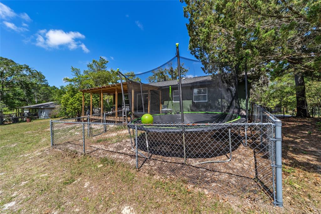 9040 Southwest 209th Circle Dunnellon, FL 34431 - Photo 39 of 55 a view of a house with a fountain and a patio