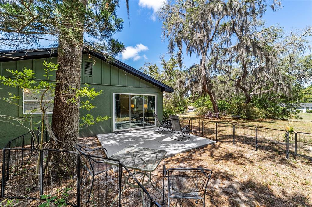 9040 Southwest 209th Circle Dunnellon, FL 34431 - Photo 41 of 55 a view of backyard with table and chairs and potted plants