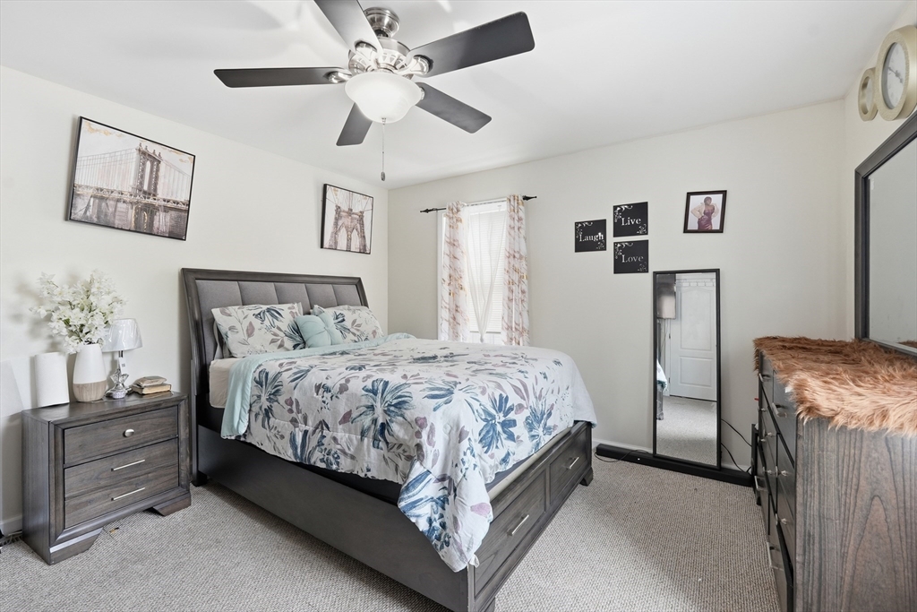 19 Annies Way Springfield, MA 01119 - Photo 21 of 40 a bedroom with a bed and a chandelier