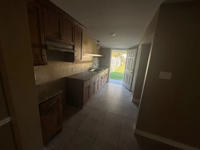 a kitchen with stainless steel appliances a sink stove and refrigerator