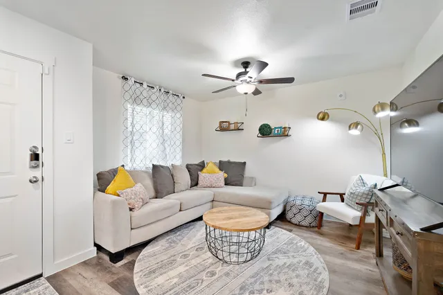 a living room with furniture a rug and a chandelier