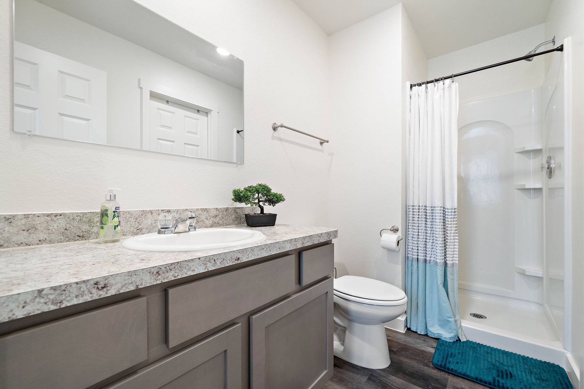 12603 Telge Road, Unit 17B Cypress, TX 77429 - Photo 18 of 21 a bathroom with a granite countertop sink toilet a mirror and shower