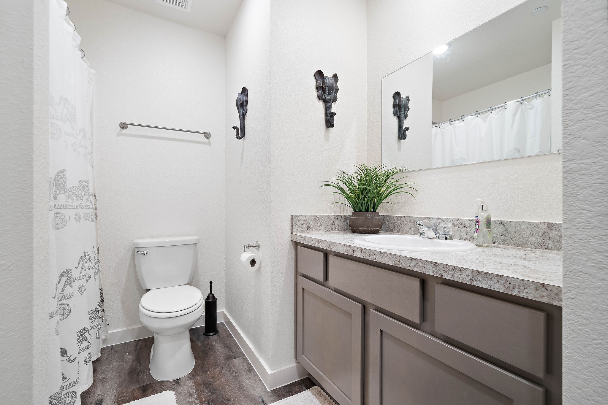 12603 Telge Road, Unit 17B Cypress, TX 77429 - Photo 20 of 21 a bathroom with a granite countertop sink a toilet and a large mirror