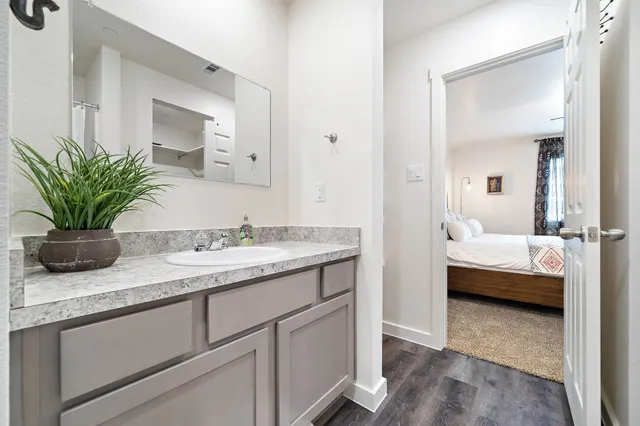 a bathroom with a granite countertop sink a mirror and a