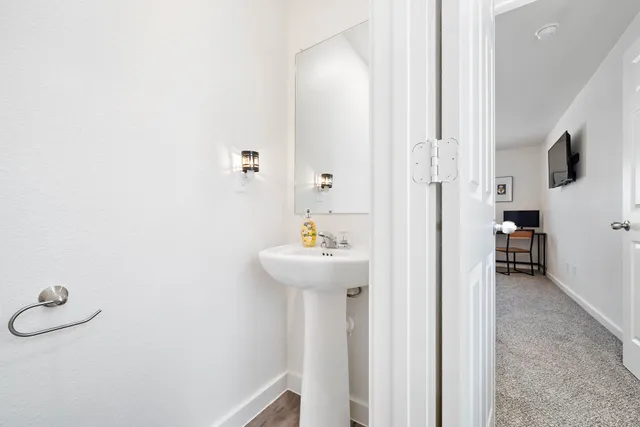 a bathroom with a sink a mirror and shower