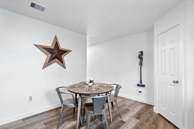 a view of a dining room with furniture and wooden floor