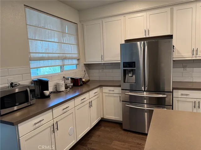 a kitchen with stainless steel appliances granite countertop a refrigerator sink and cabinets