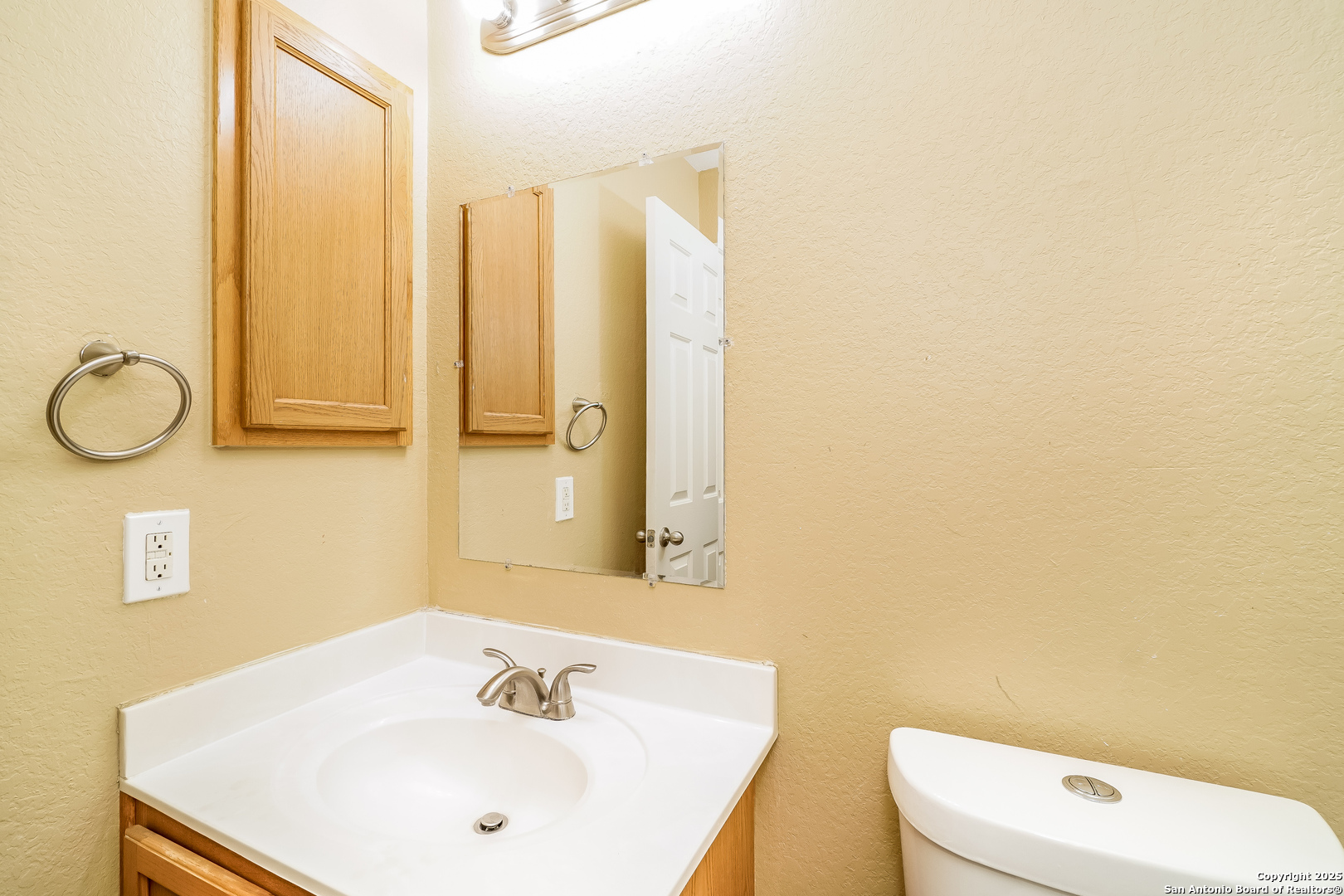 3519 Aranda Fields Converse, TX 78109 - Photo 13 of 16 a bathroom with a sink a toilet and mirror