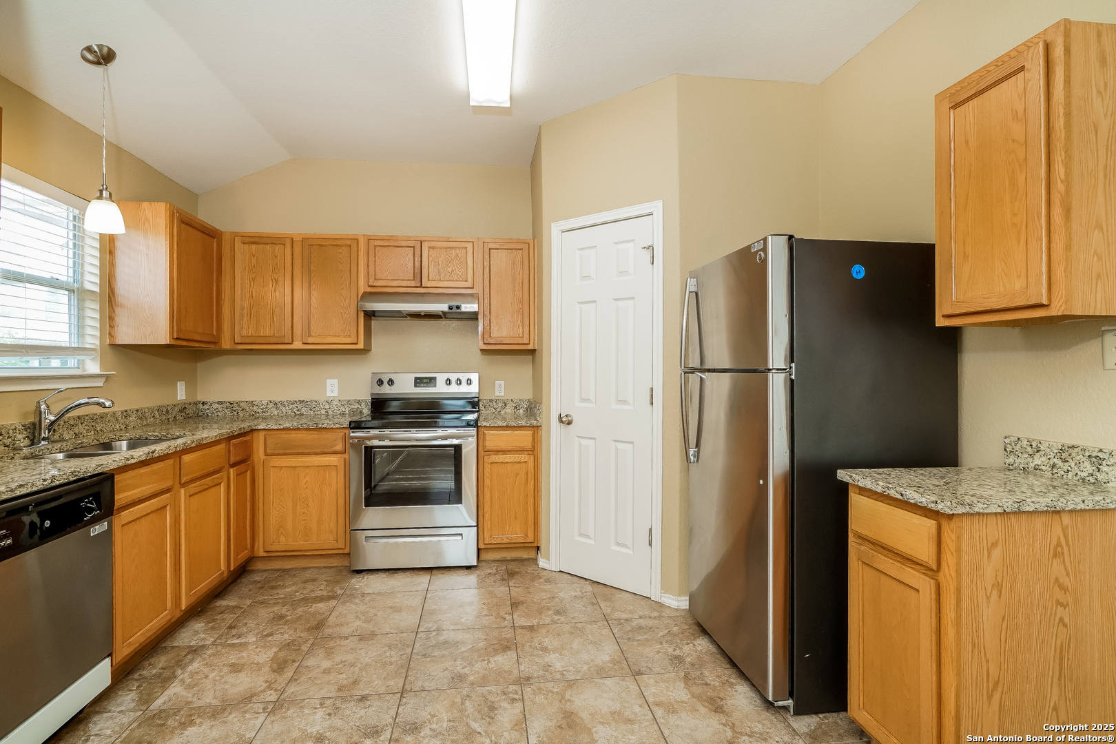 3519 Aranda Fields Converse, TX 78109 - Photo 7 of 16 a kitchen with granite countertop a refrigerator and a sink