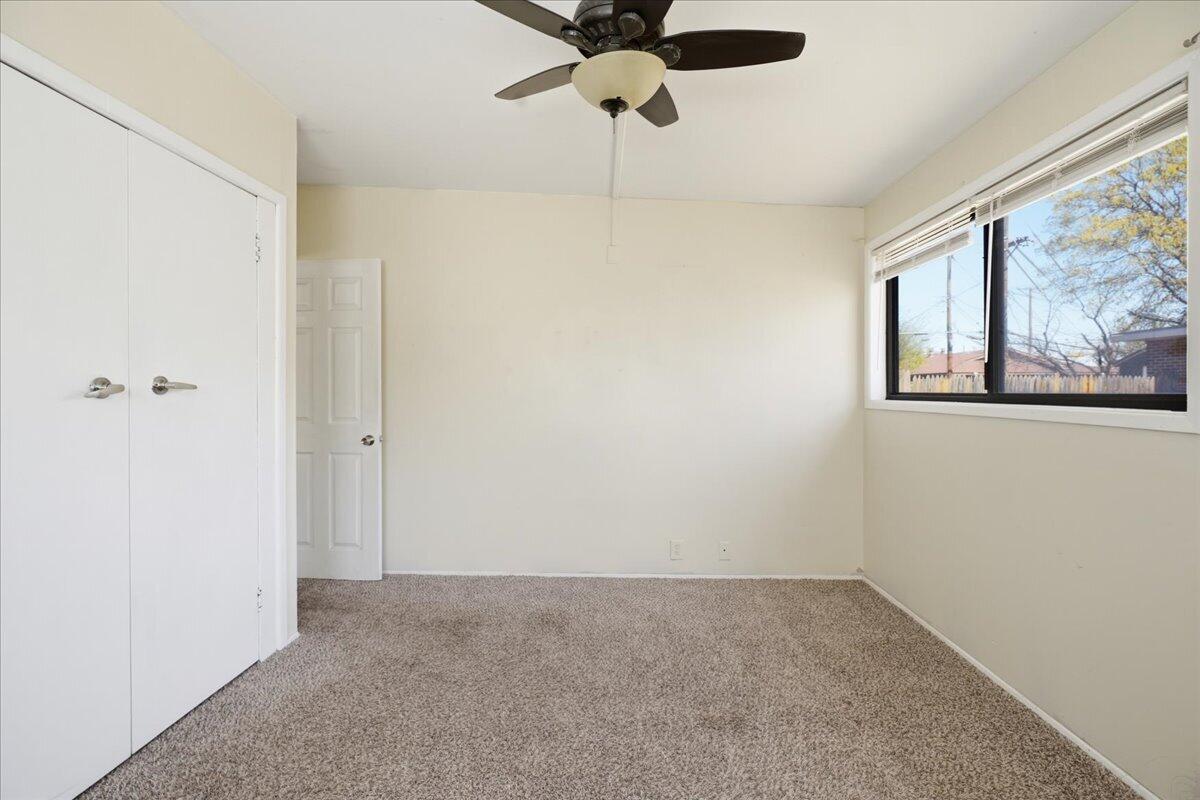 2706 68th Street Lubbock, TX 79413 - Photo 14 of 20 a view of an empty room with a fan