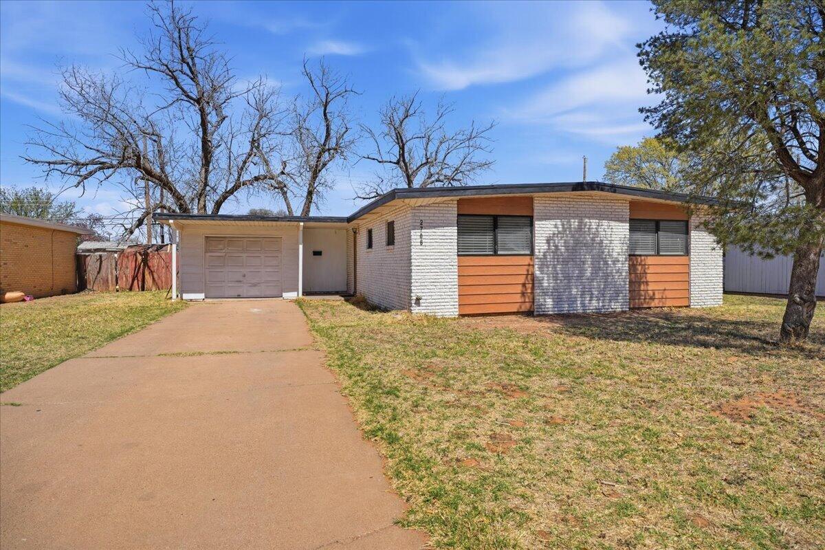 2706 68th Street Lubbock, TX 79413 - Photo 2 of 20 a front view of house with yard