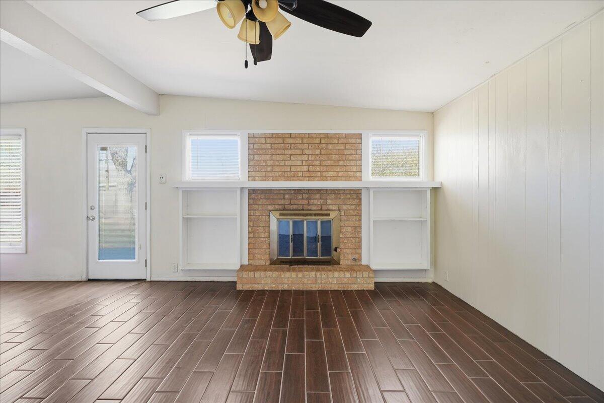2706 68th Street Lubbock, TX 79413 - Photo 5 of 20 wooden floor in an empty room with a window